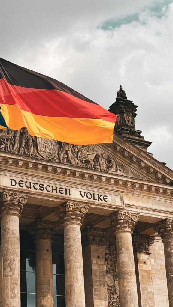 German flag above the Reichstag representing TestDaF vs Goethe German exam choice